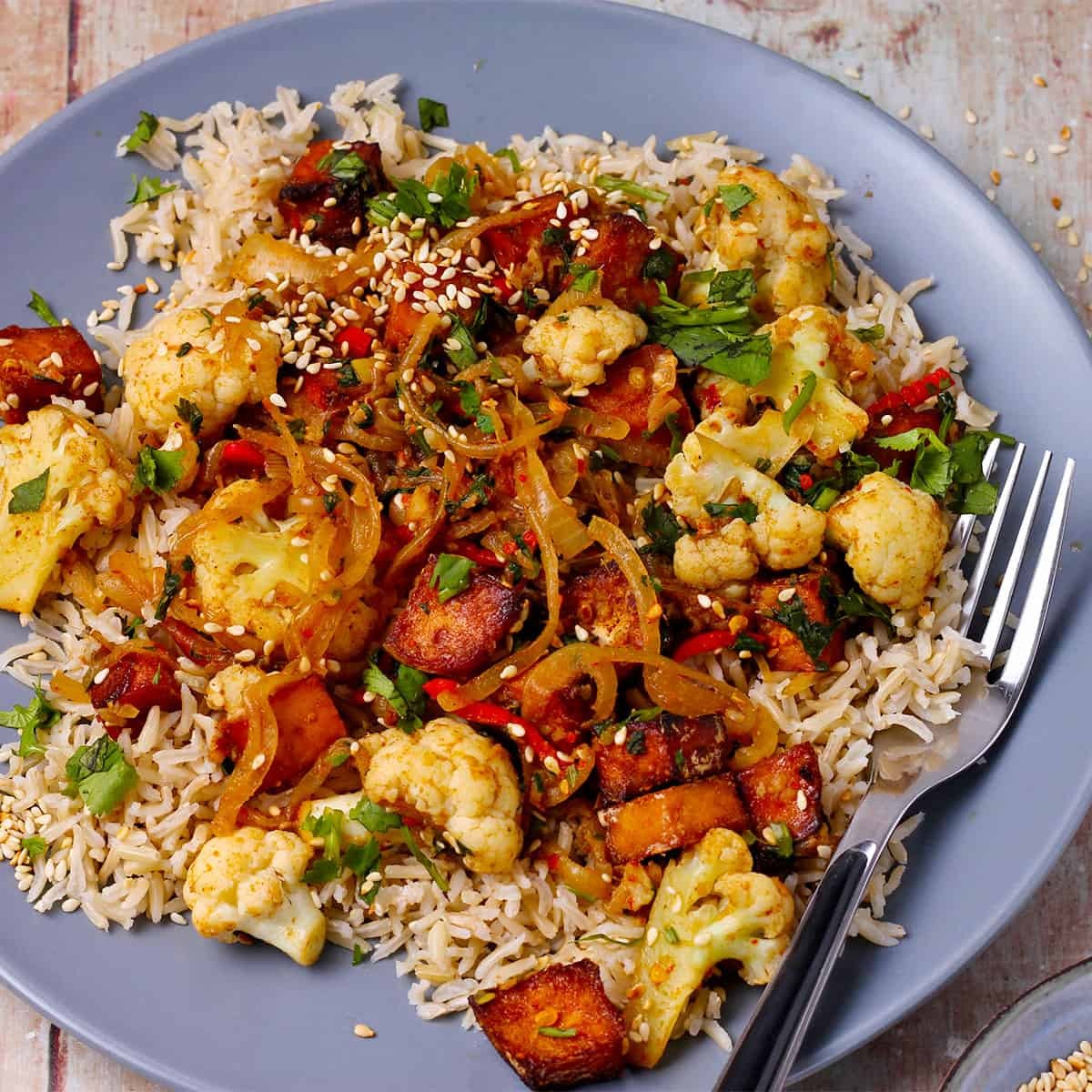 vibrant tofu and cauliflower stir-fry in a wok