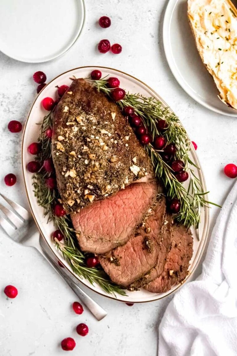 succulent garlic butter roast beef on a festive platter with holiday decorations