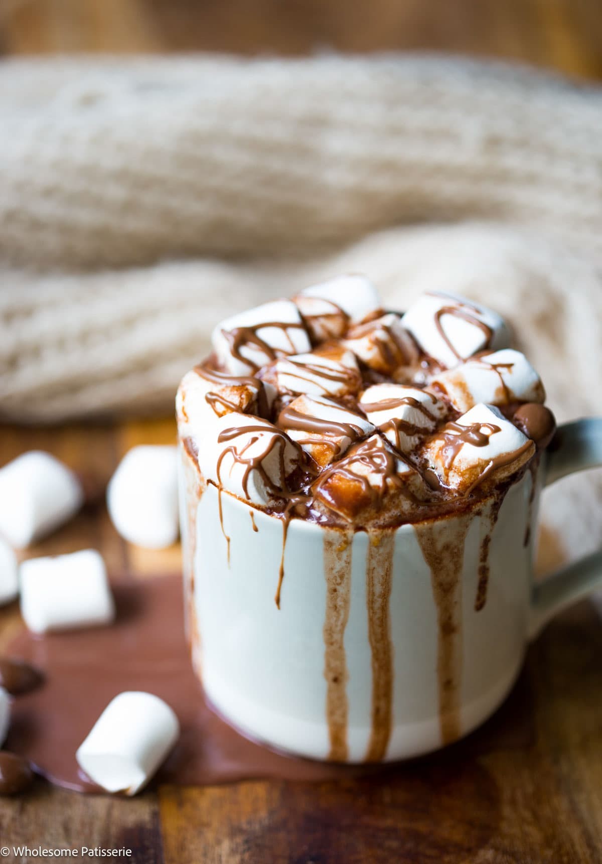 Decadent molten truffle hot chocolate in a cozy mug, garnished with chocolate shavings and a hint of steam, close-up