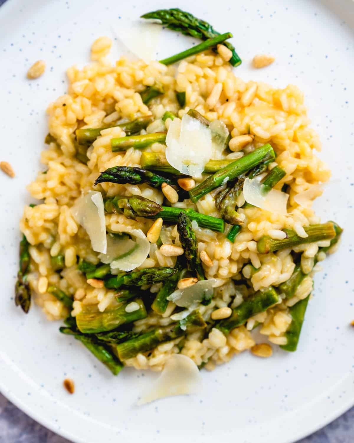creamy asparagus risotto topped with toasted pine nuts and parmesan cheese