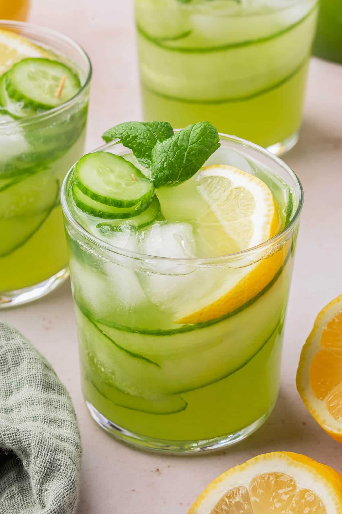 Refreshing glass of cucumber mint limeade with ice and lime wedge