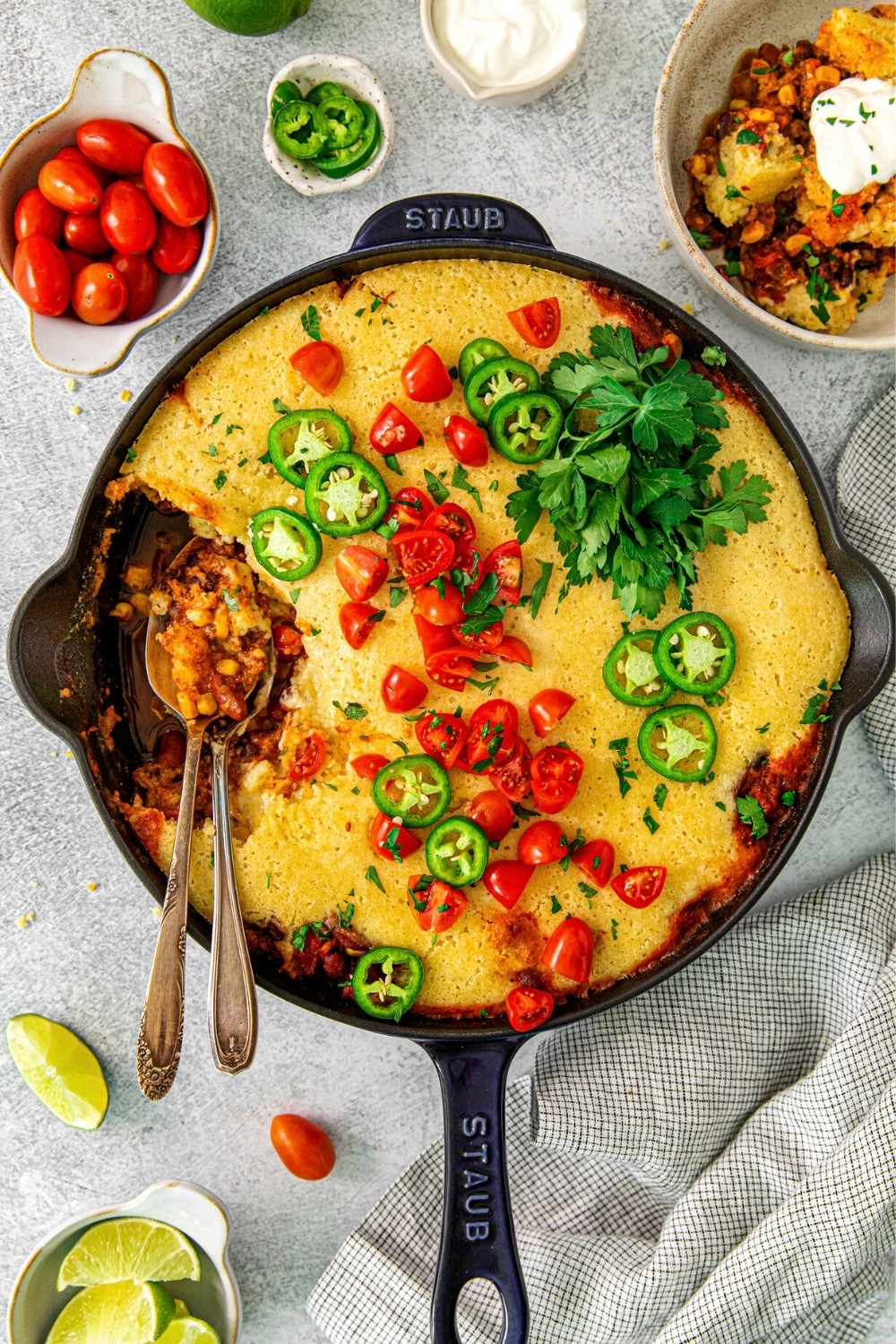 Rustic cast iron skillet corn casserole on a wooden table, cozy kitchen background