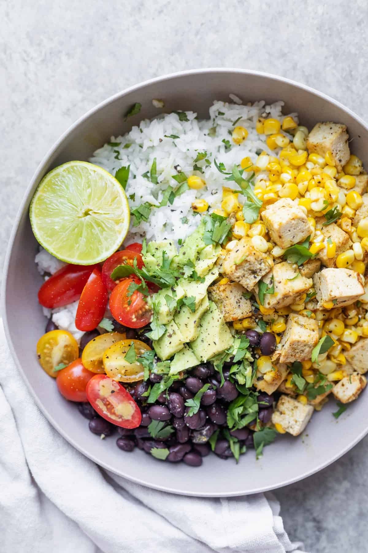 a vibrant black bean and corn tofu rice bowl