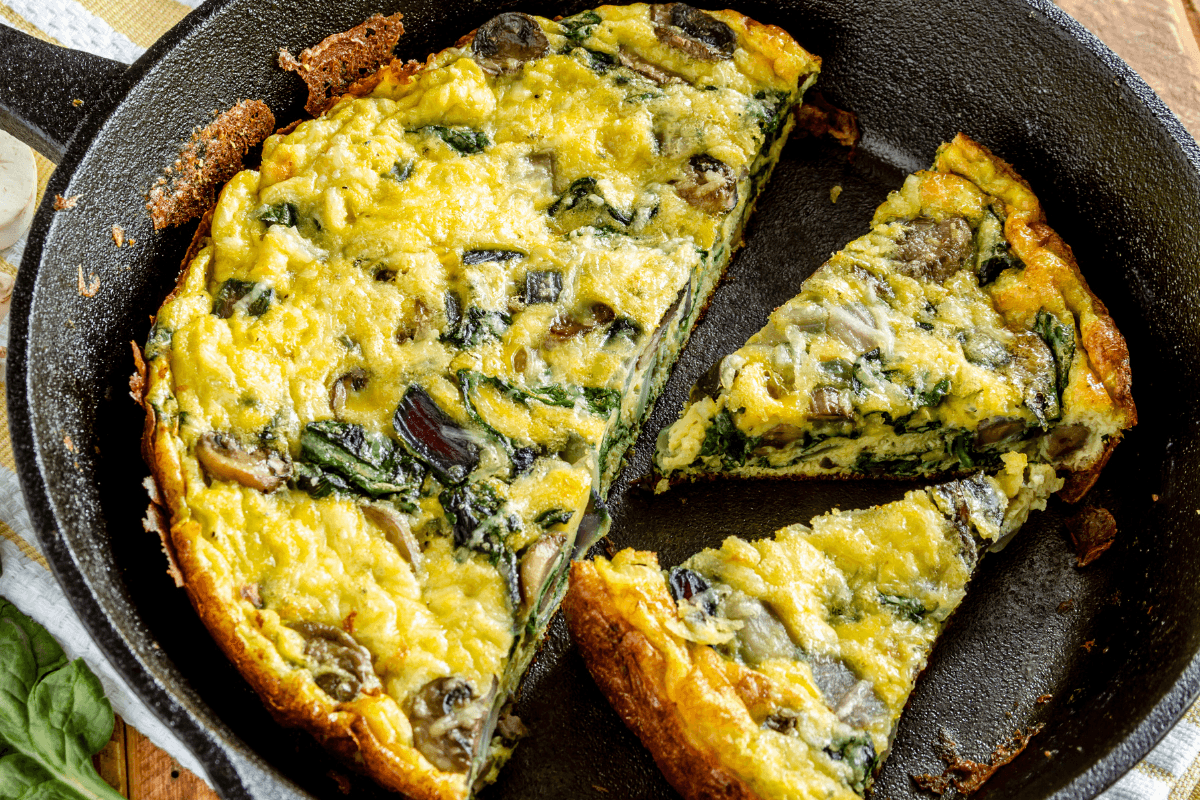 Spinach and feta frittata with pine nuts on a rustic wooden table