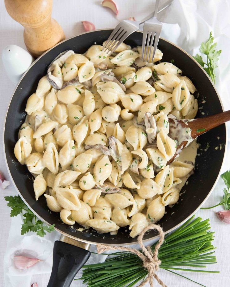 creamy mushroom pasta dish with fresh parsley garnish, overhead shot