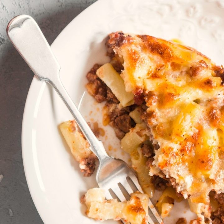 golden bubbling cheesy baked ziti in a casserole dish, steam rising