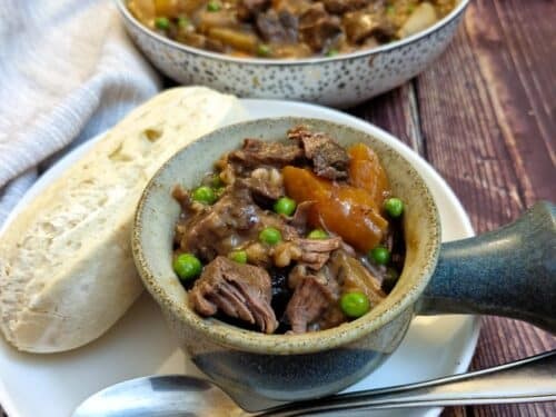 hearty beef stew in a slow cooker, rustic kitchen setting, steam rising, warm lighting