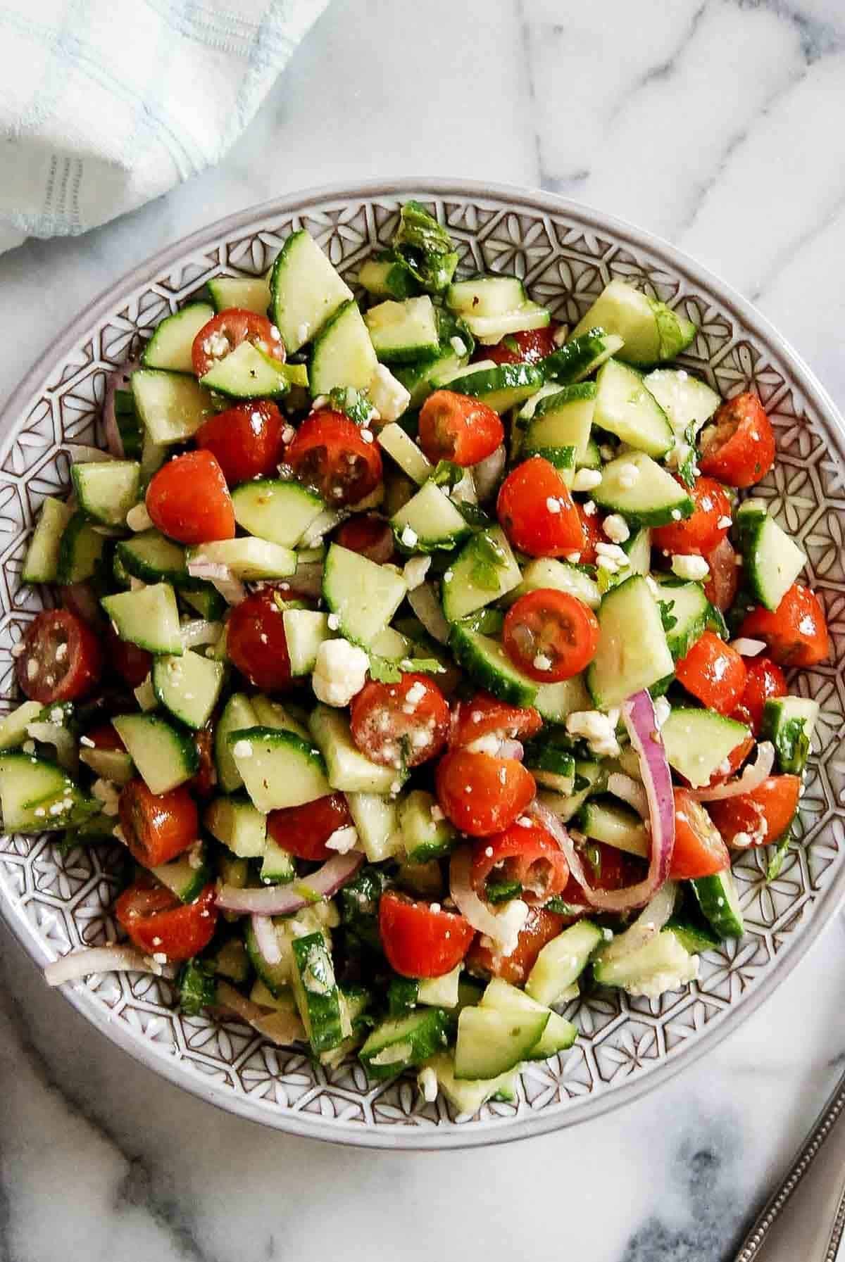 close up shot of greek tabbouleh salad with tomatoes and cucumbers