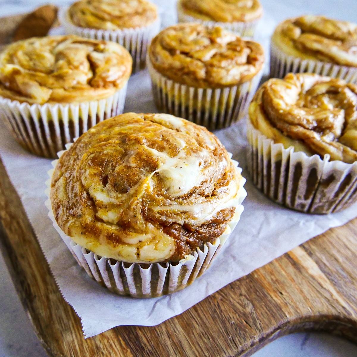 pumpkin cream cheese muffins with a cream cheese swirl