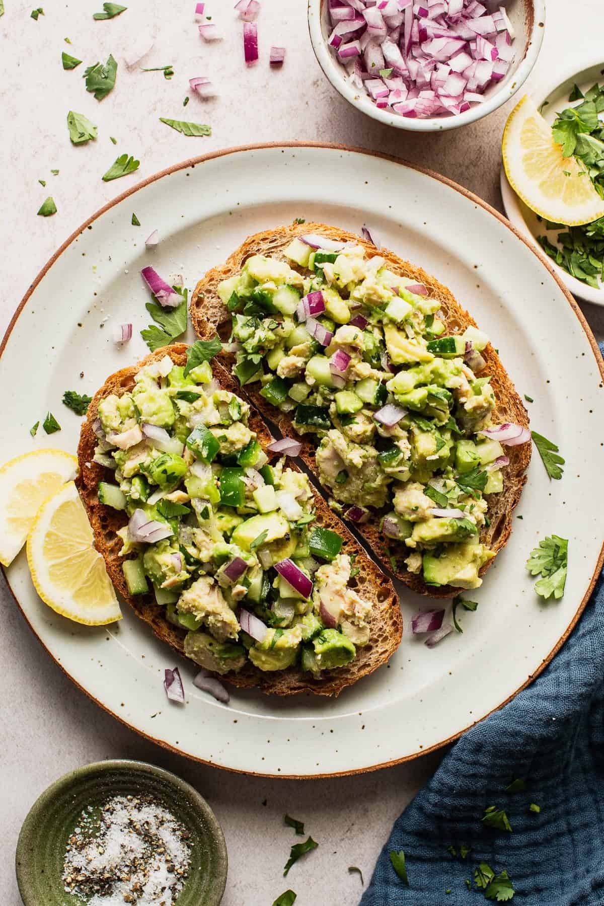A slice of avocado toast with a side of tuna salad