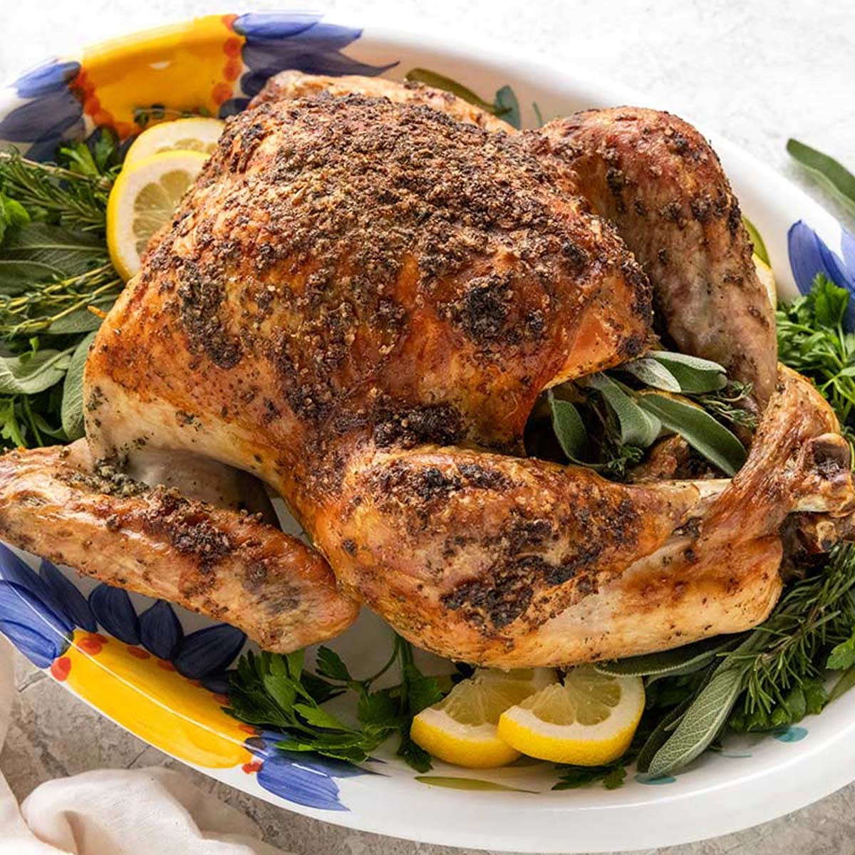 whole roasted turkey with golden skin, fresh herbs, and melted butter, rustic holiday setting