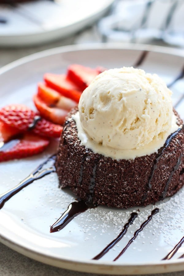 molten chocolate lava cake with vanilla ice cream and a spoon