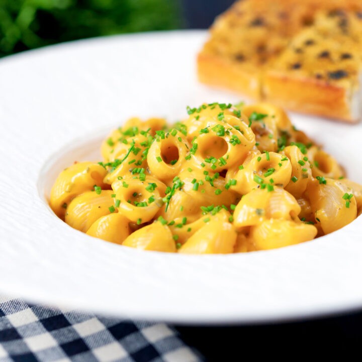 Close-up shot of a plate of Roasted Butternut Squash Pasta with Sage, garnished with fresh sage leaves