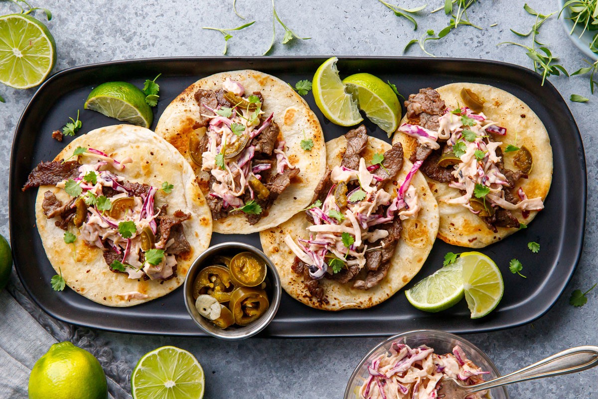 beef tacos topped with cilantro lime slaw