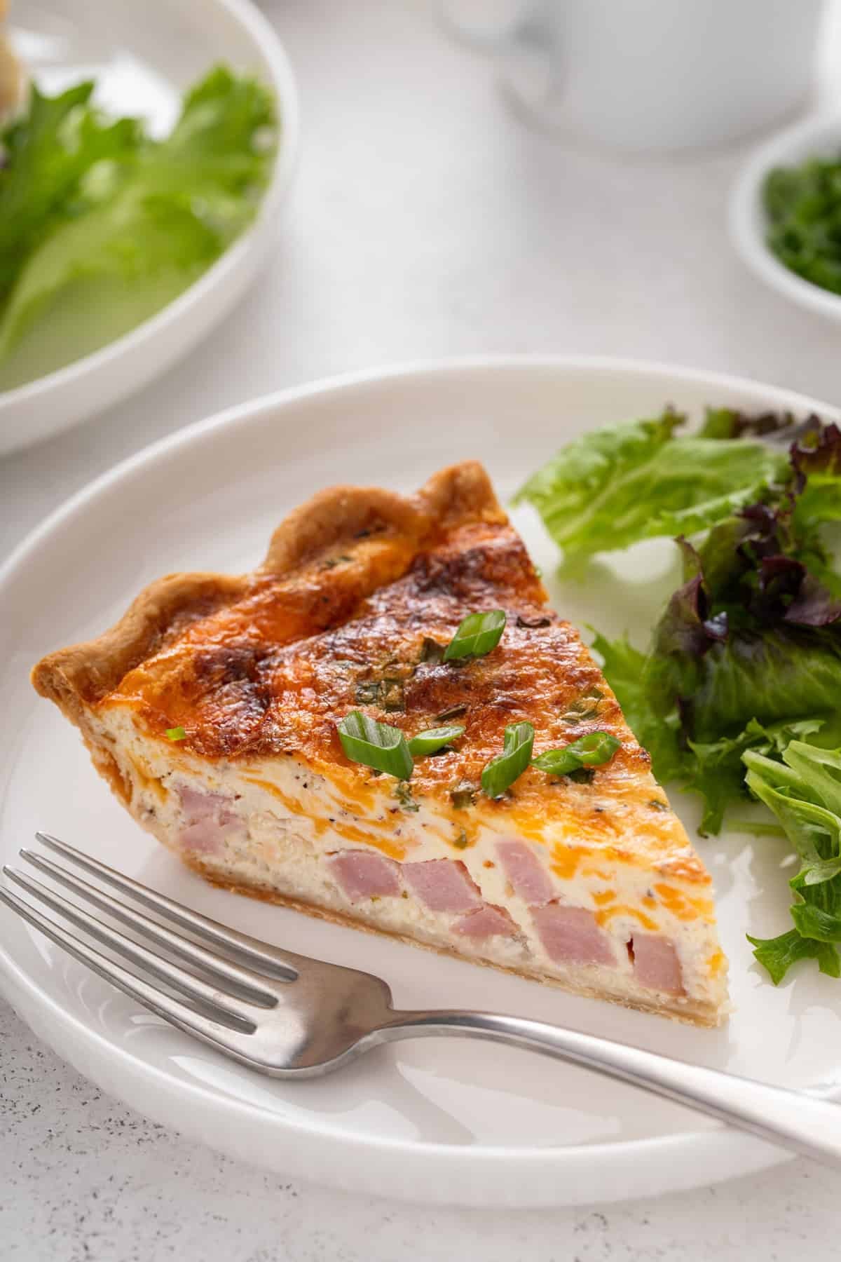 close up of ham and cheddar quiche bites on a plate
