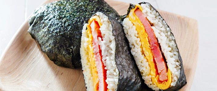A vibrant and appetizing close-up shot of a Rice Riot Wrap, showcasing the colorful ingredients and texture of the filling.
