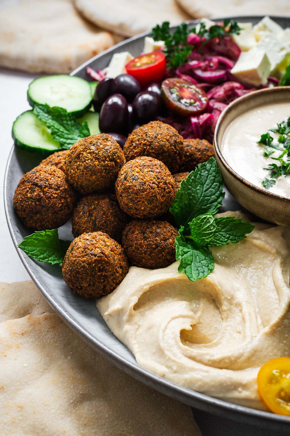 Nori falafel plated with tahini sauce and fresh herbs