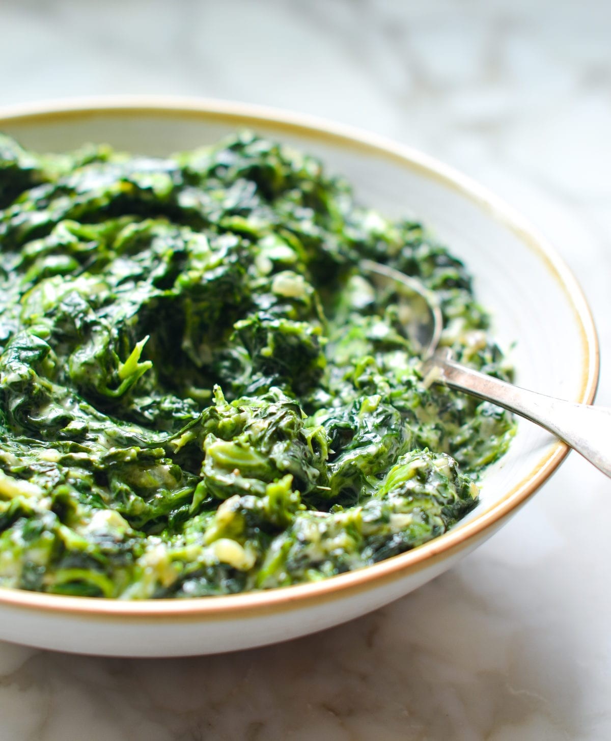 Delicious creamy spinach side dish close up with a velvety sauce