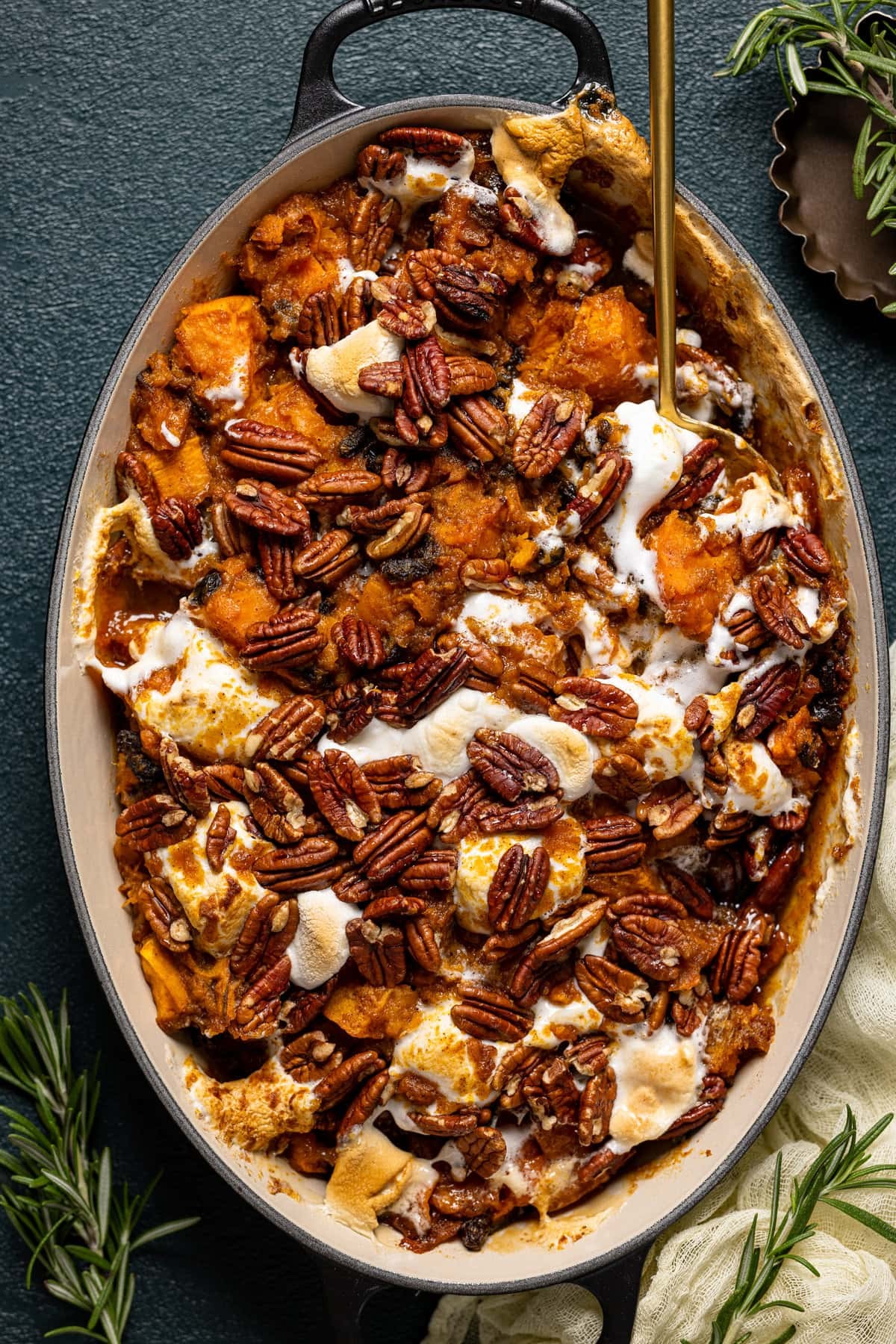 golden sweet potato casserole with maple butter drizzle and crunchy pecans, set on a rustic wooden table with autumn decorations