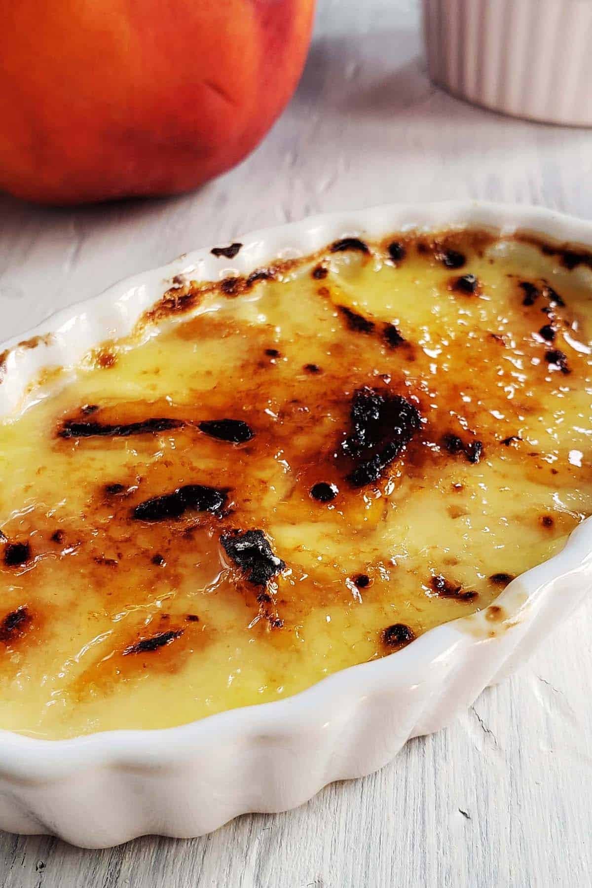 close up shot of peach rose crème brûlée with caramelized sugar crust