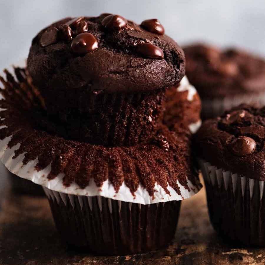 delicious chocolate cookie muffins with a gooey chocolate center, warm, rustic lighting, baked goods