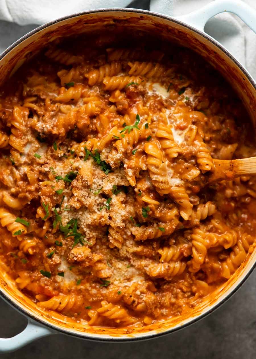 hearty creamy ground beef pasta in a rustic bowl, garnished with fresh parsley