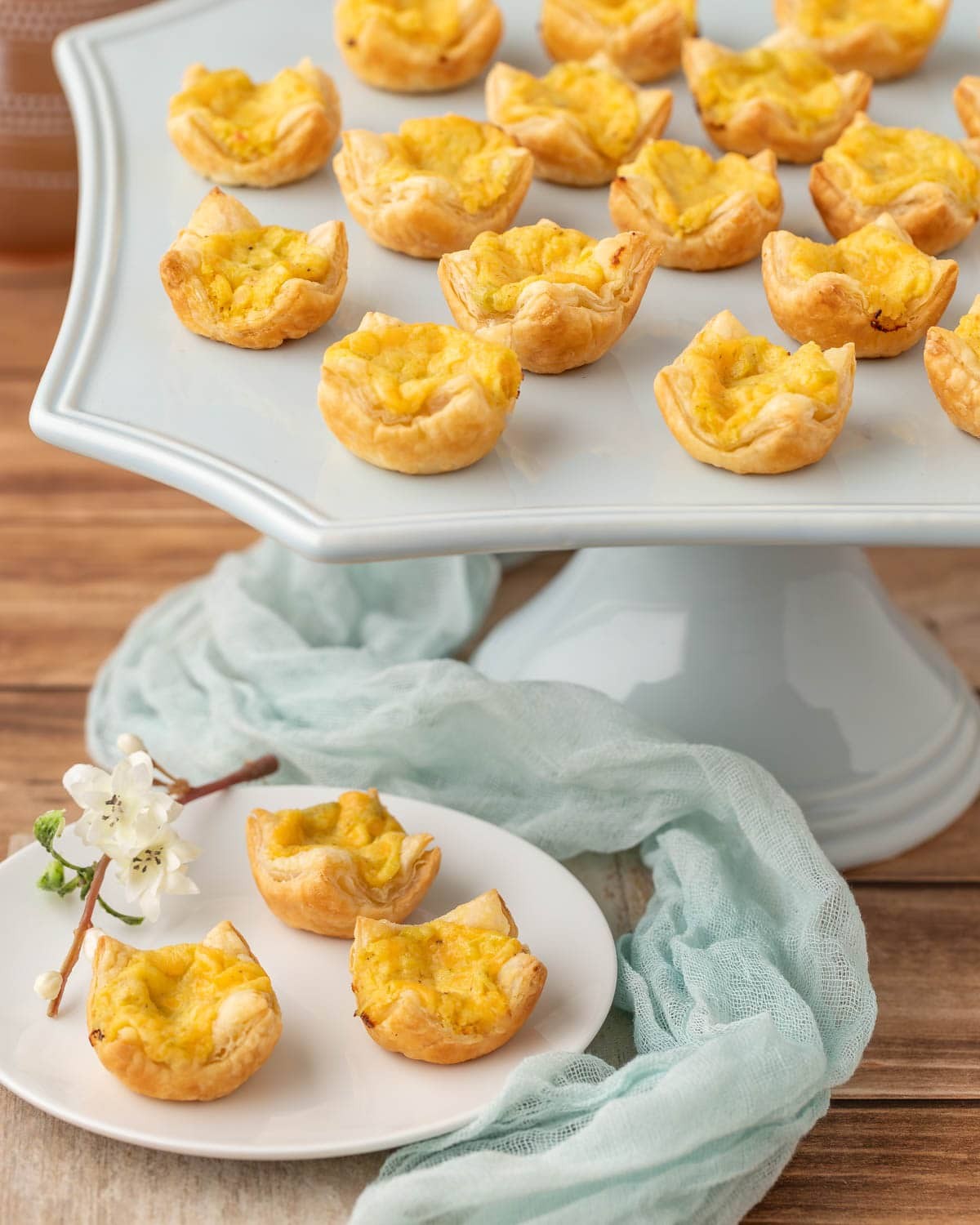 mini cheese tarts with golden savory crust on a serving platter