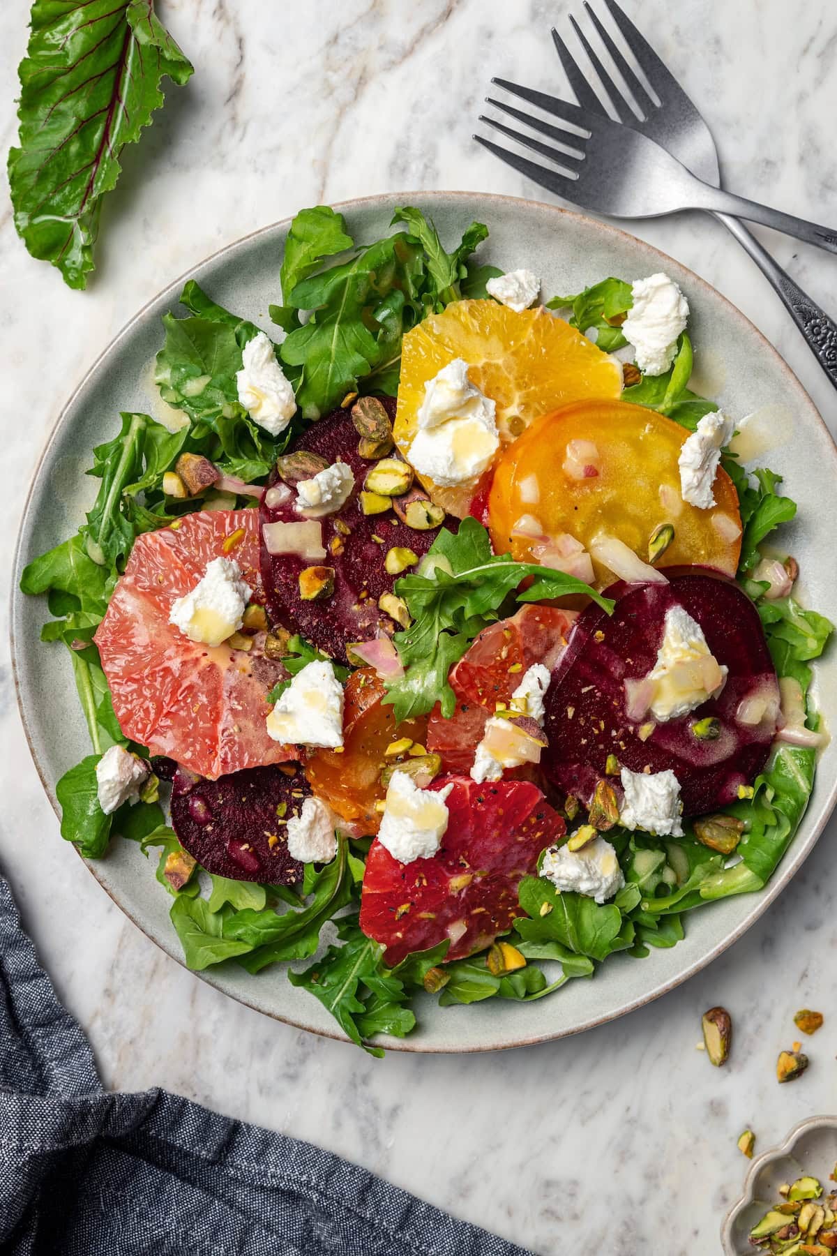 bright, colorful roasted beet salad with oranges and goat cheese, natural light