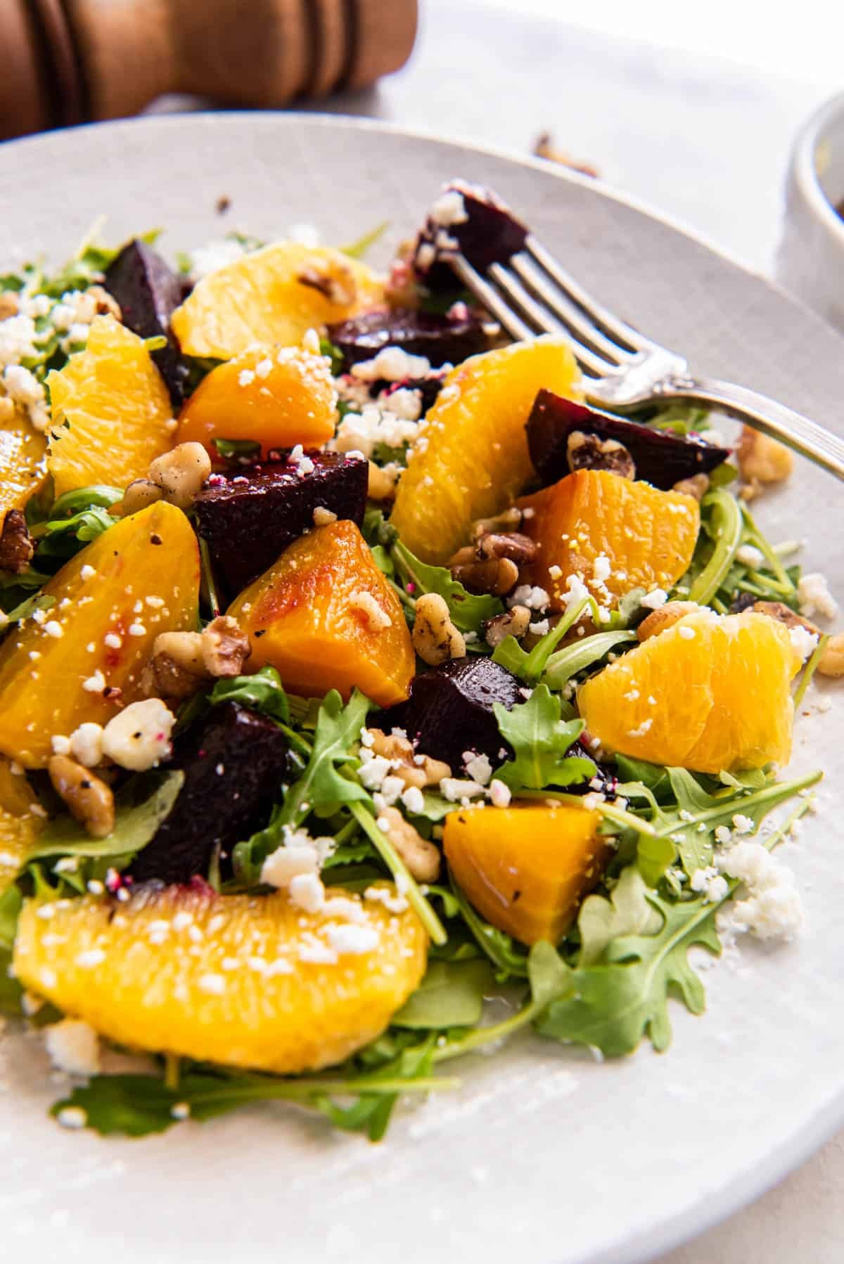 vibrant beet salad with orange segments and walnuts, close-up shot