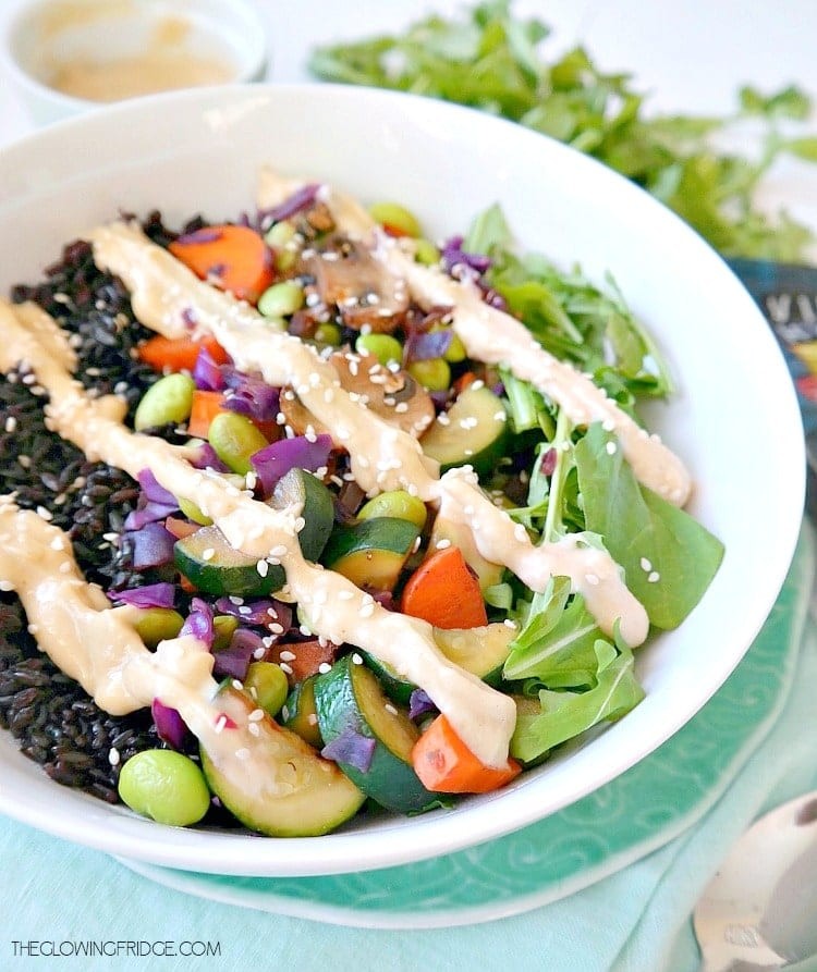 A vibrant bowl of forbidden black rice with avocado, edamame, and colorful toppings