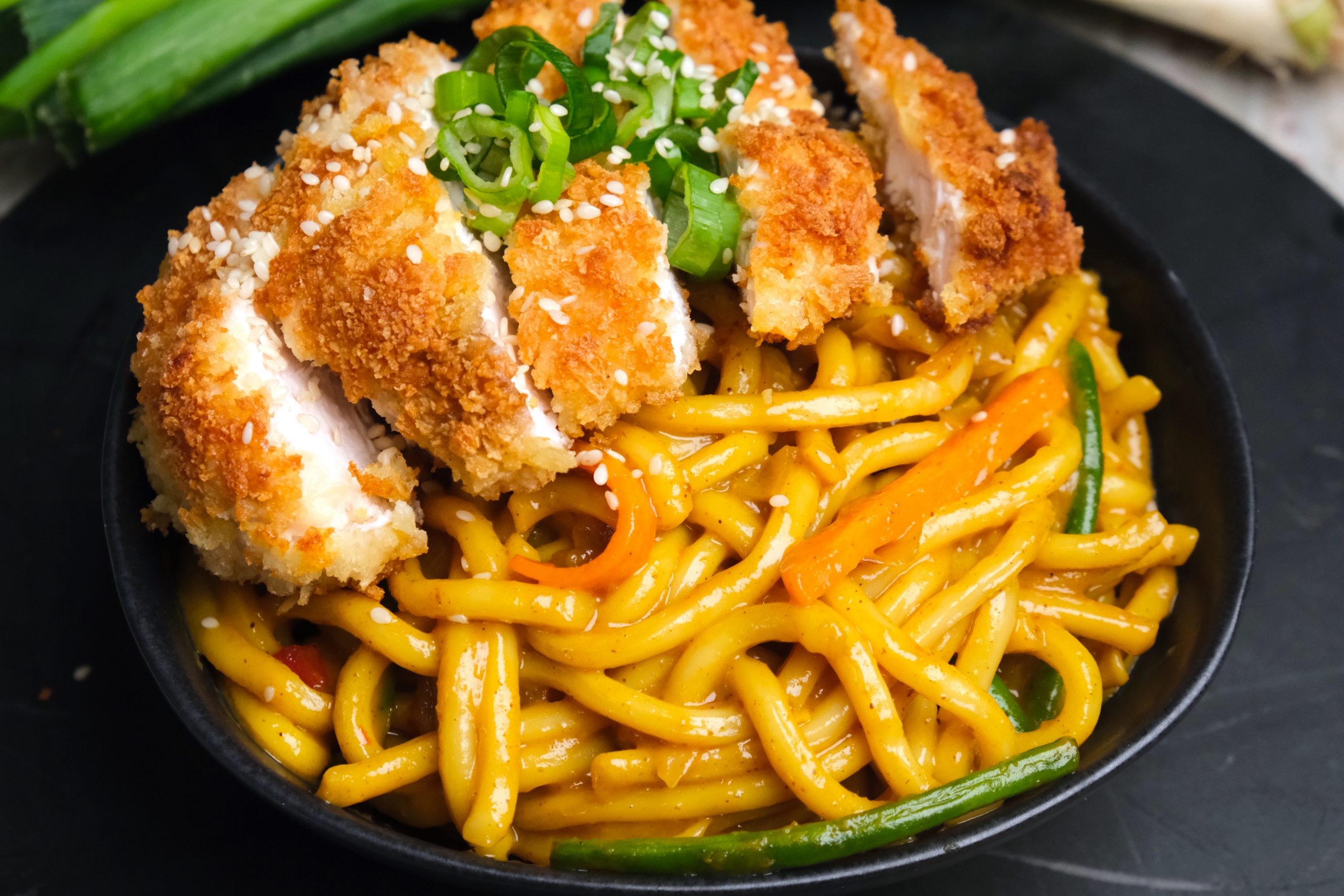 bowl of curry udon with crispy chicken katsu on top