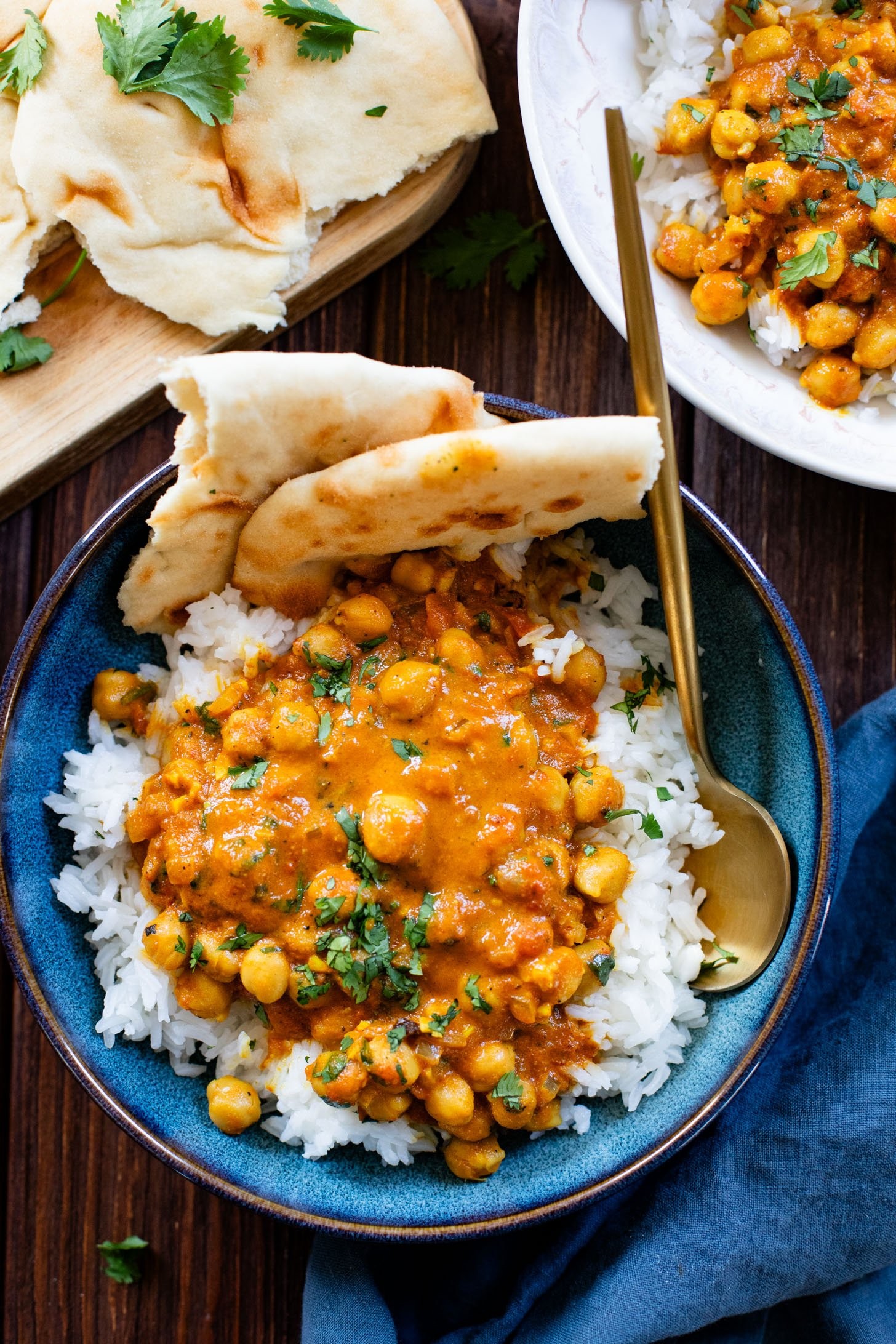 bowl of homemade chickpea curry with rice and naan