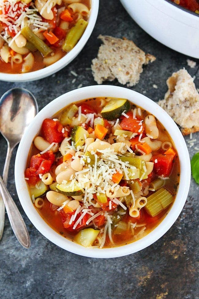 Bowl of steaming minestrone soup with crusty bread