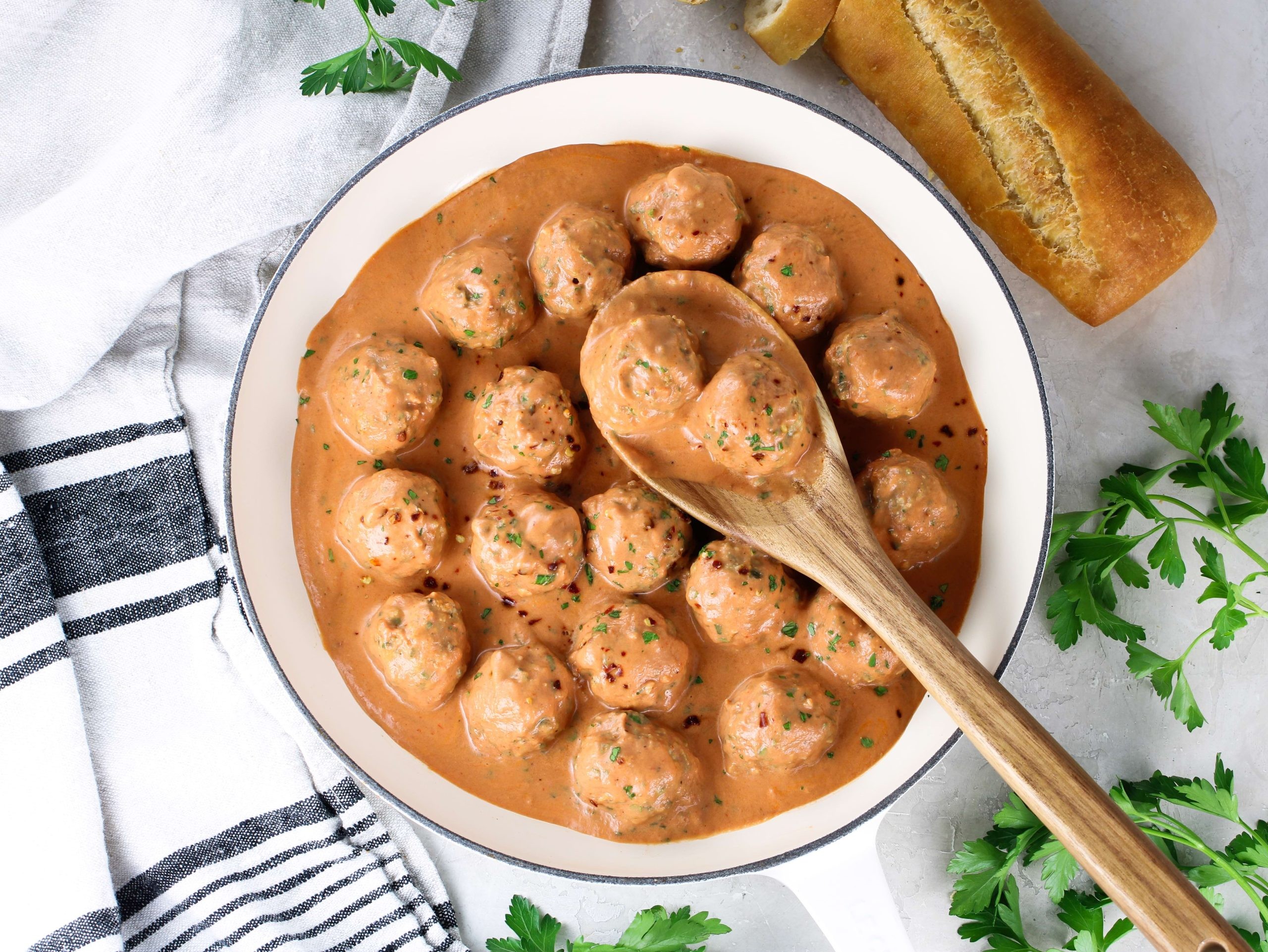 Close-up shot of creamy tomato köttbullar with parmesan, showcasing the rich sauce and meatballs