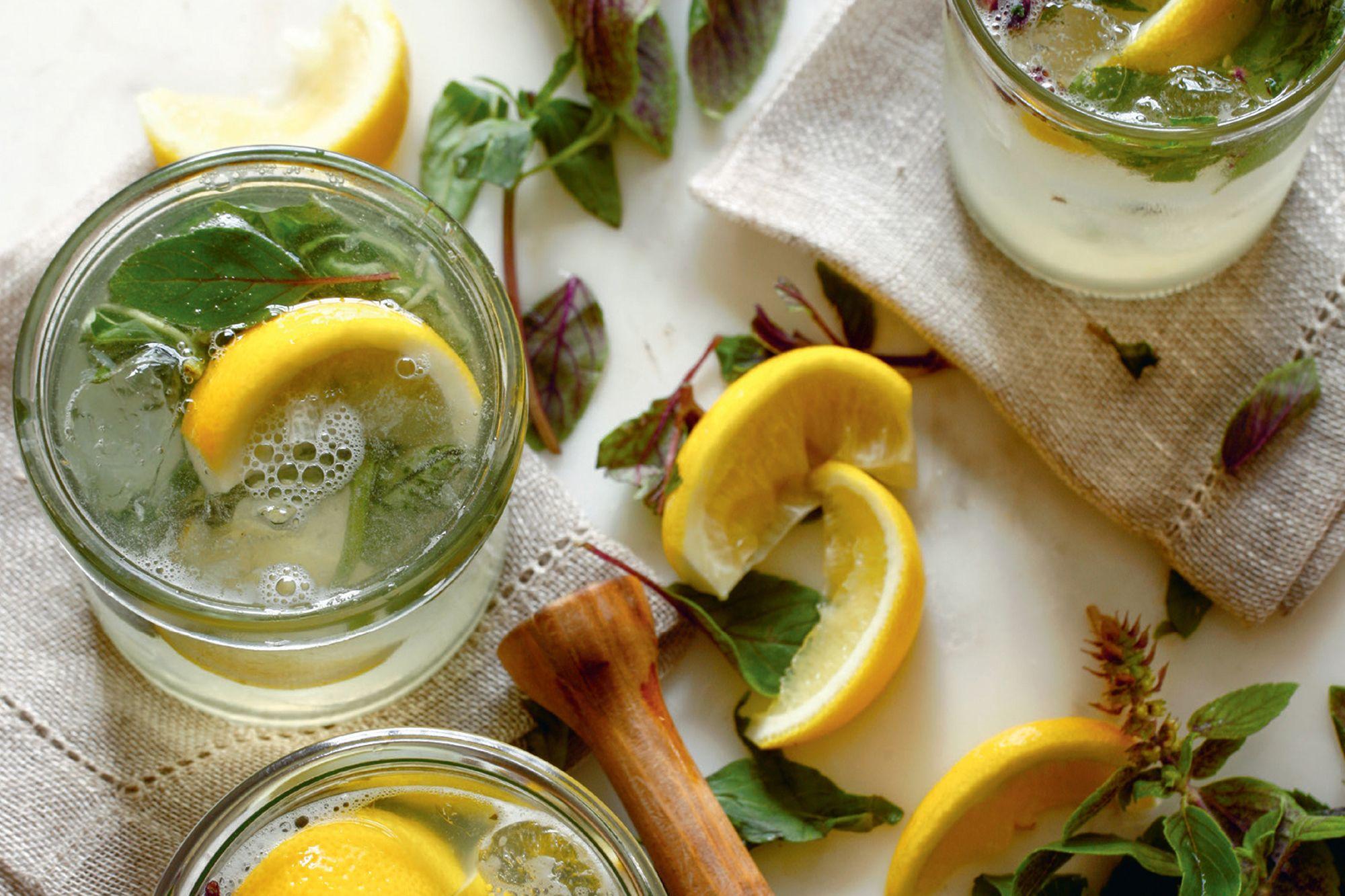 A glass of Basil-infused Gin garnished with a basil sprig.