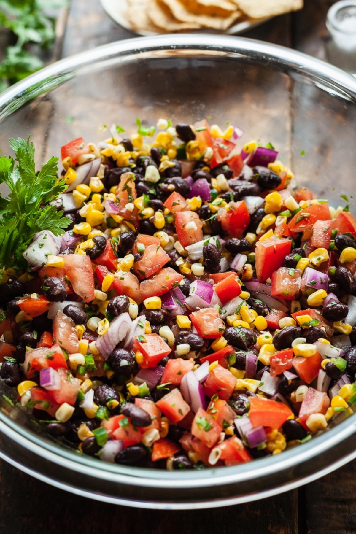 Close-up of a bowl of Roasted Corn & Black Bean Fattoush, showing the vibrant colors and textures