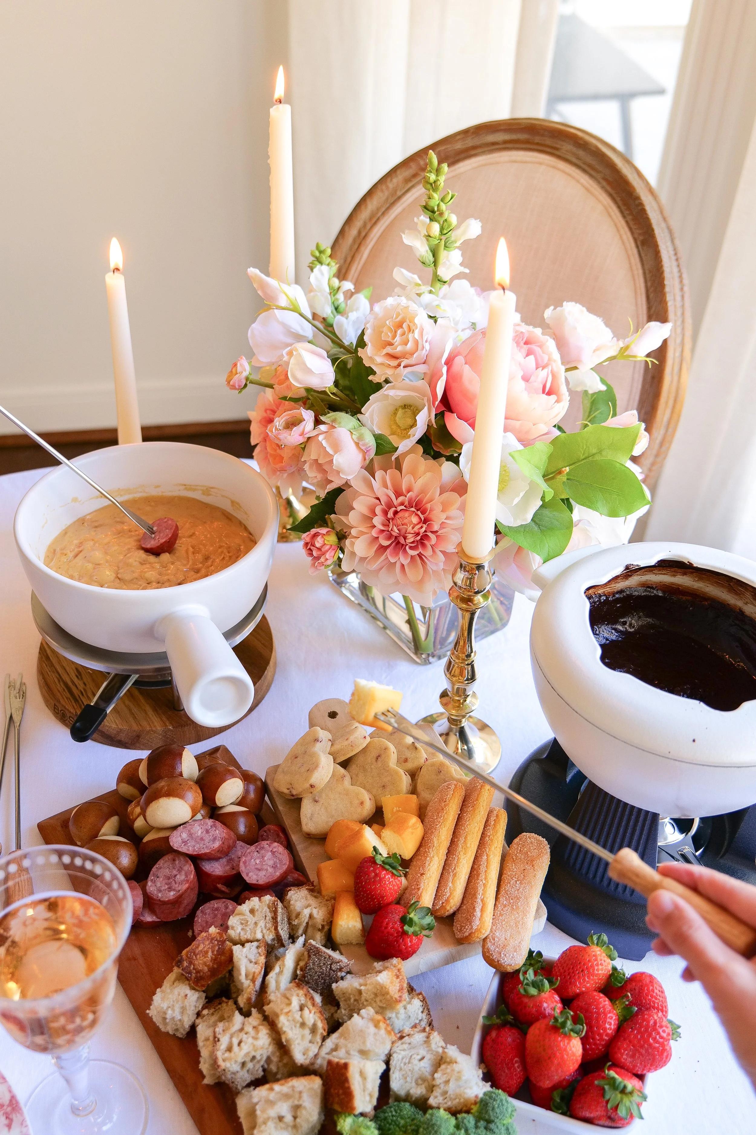 elegant raspberry and champagne fondue setup with candles