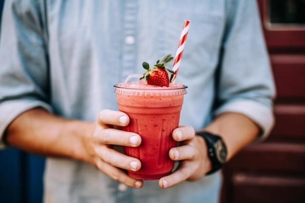 Person enjoying a smoothie outdoors