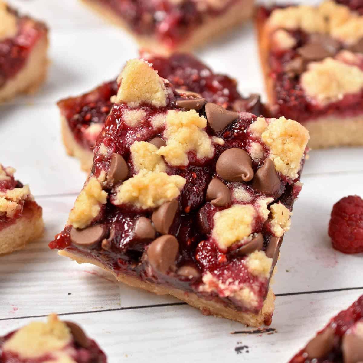 A rustic kitchen scene with a baking dish of lingonberry crumble cooling on a wooden countertop