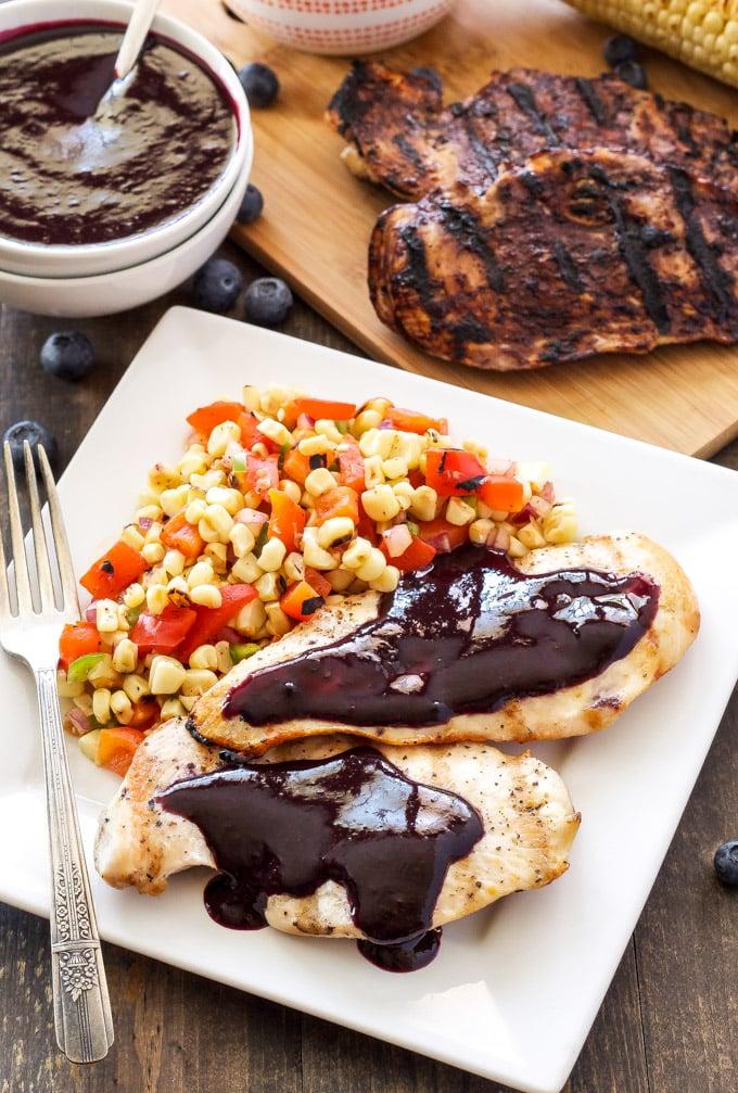 A bowl of grilled corn and blueberry salsa with grilled chicken or fish