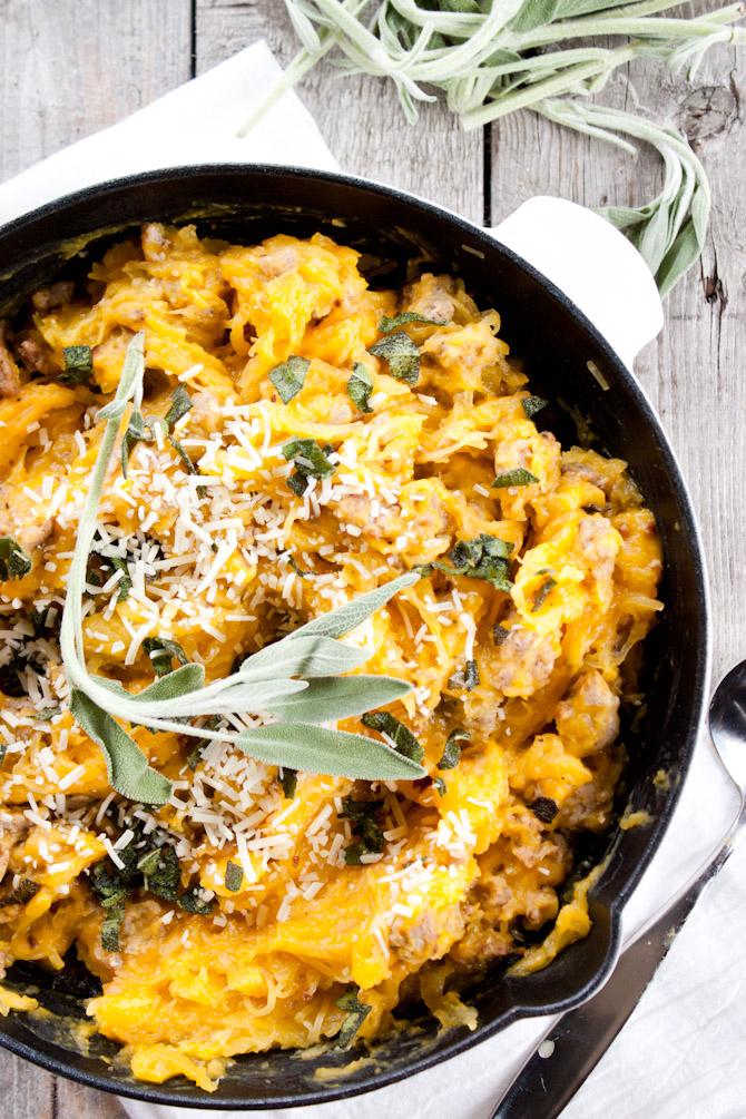 Butternut squash and sausage pasta with creamy sage sauce in a rustic bowl