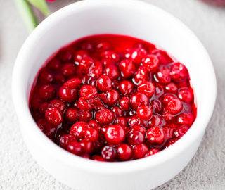 A close-up shot of a bowl filled with lingonberries