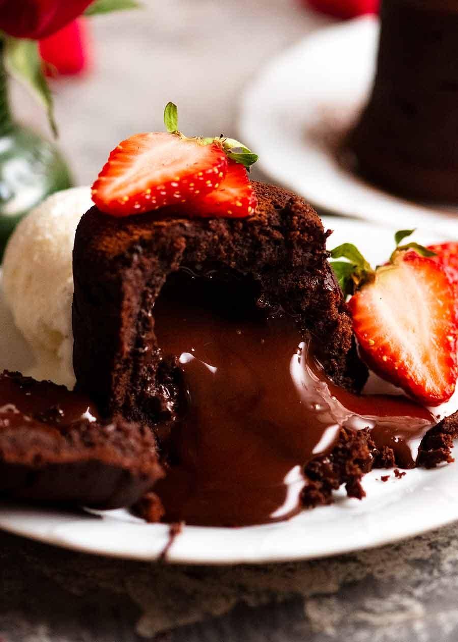 Close-up of a molten chocolate cake being served with ice cream