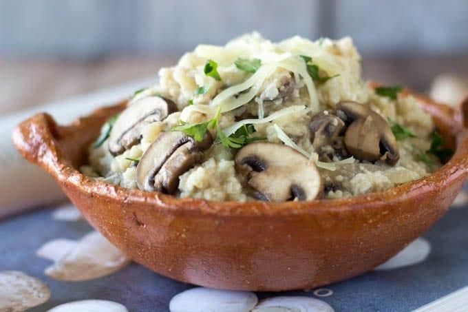 bowl of cauliflower rice risotto with wild mushrooms and truffle oil