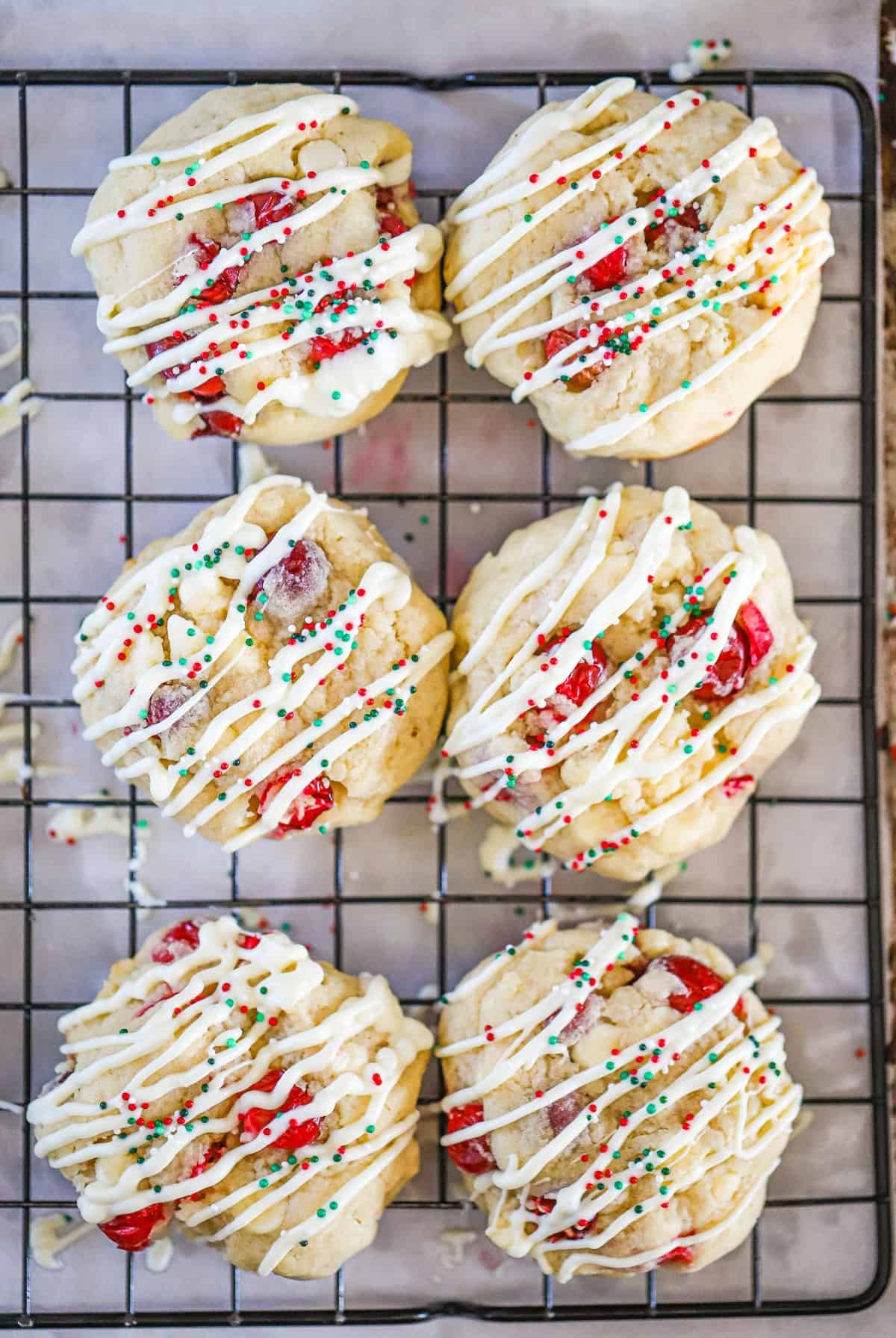 Festive cranberry white chocolate swirl bars on a cooling rack with holiday decor