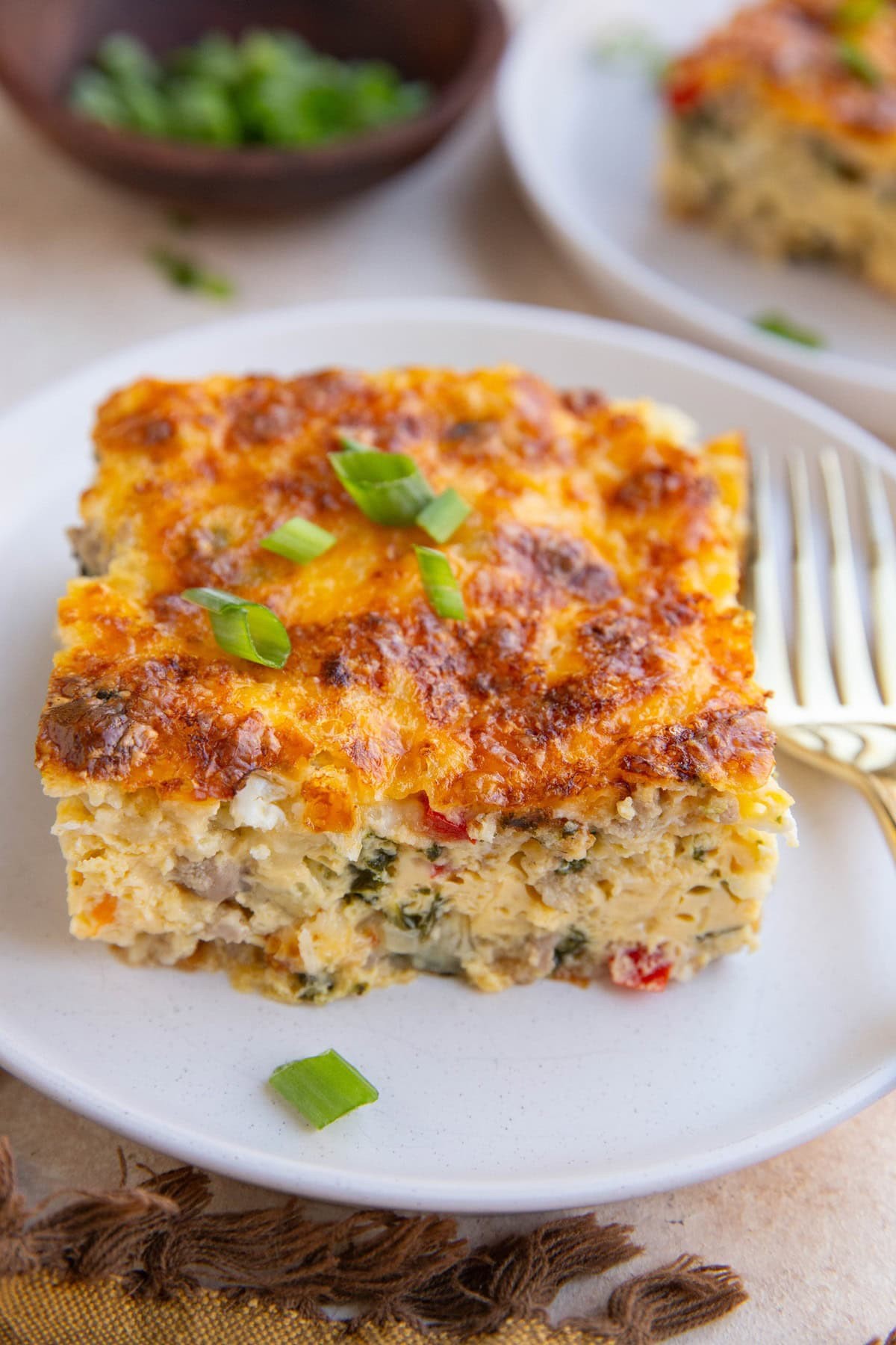 Warm cheesy egg bake casserole with fresh herbs, rustic kitchen setting