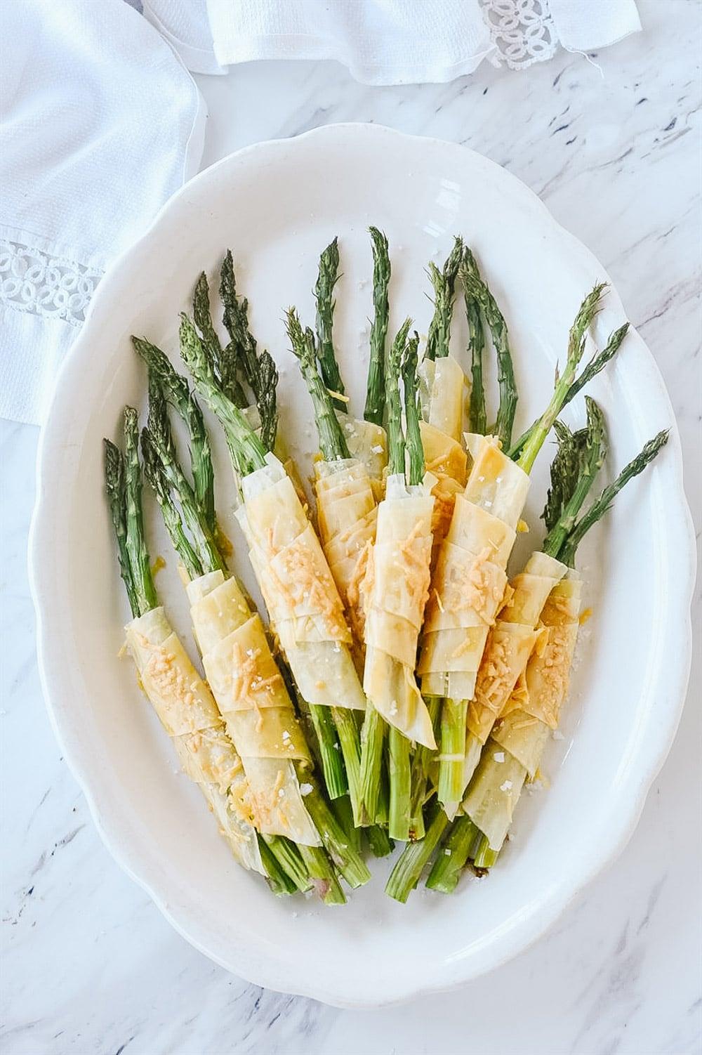 overhead shot of basil wrapped asparagus plated nicely
